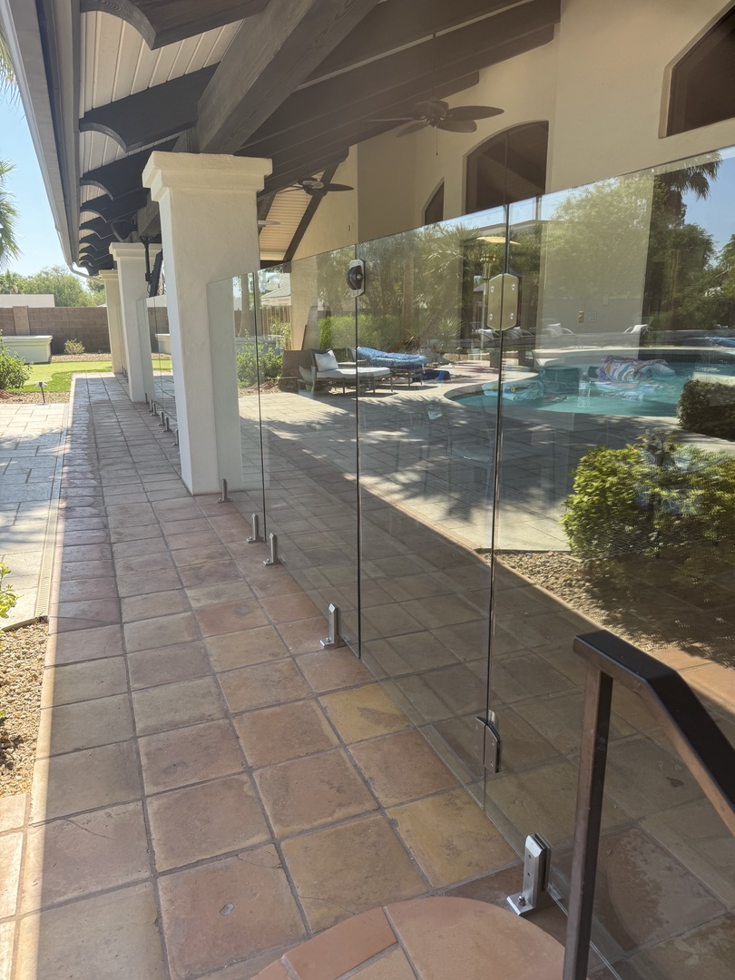 Modern property featuring clean lines and outdoor pool surrounded by palm trees and landscaping, offering a tranquil setting for your stay.