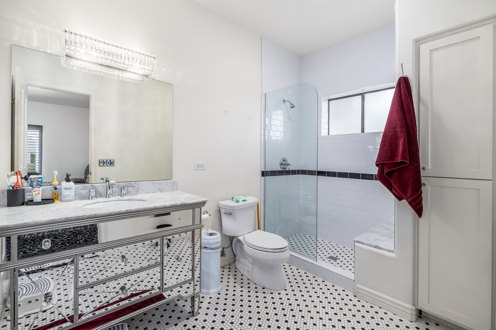 Step into your elegant private bathroom with classic tilework, a walk-in glass shower, and gleaming fixtures—your personal spa awaits after each day of adventure.
