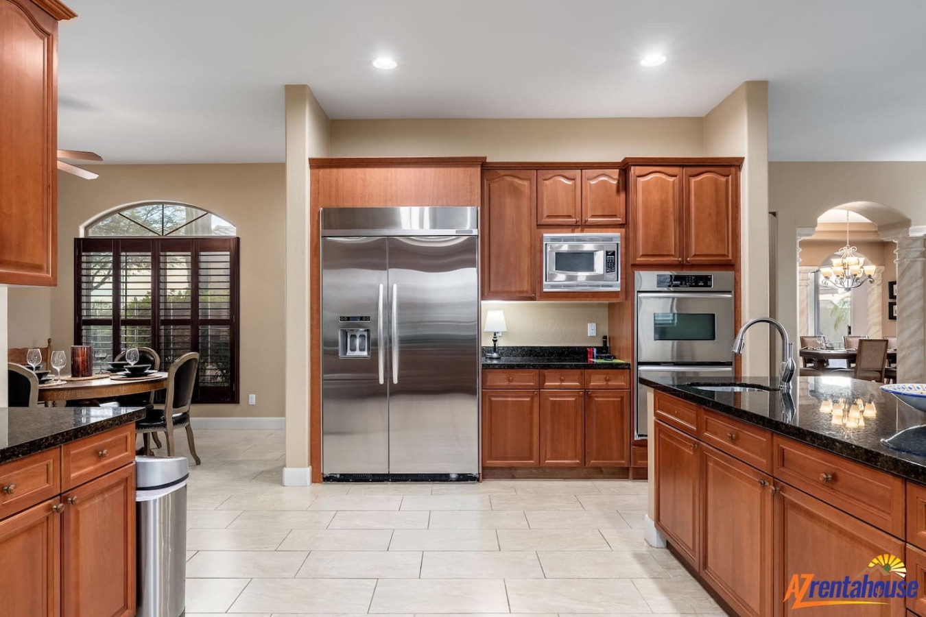 Cook with ease in your gourmet kitchen featuring stainless appliances, granite counters, and cherry cabinets.
