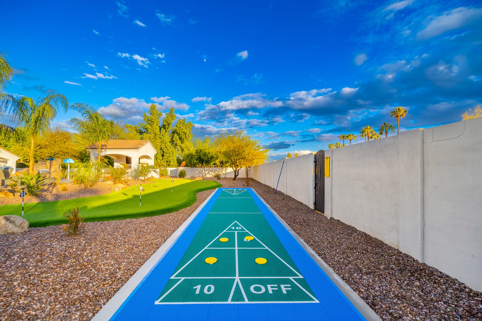 Challenge friends or family on your private shuffleboard court, framed by lush desert landscaping and sunny Arizona skies. Perfect for afternoons of friendly competition in your own backyard oasis.