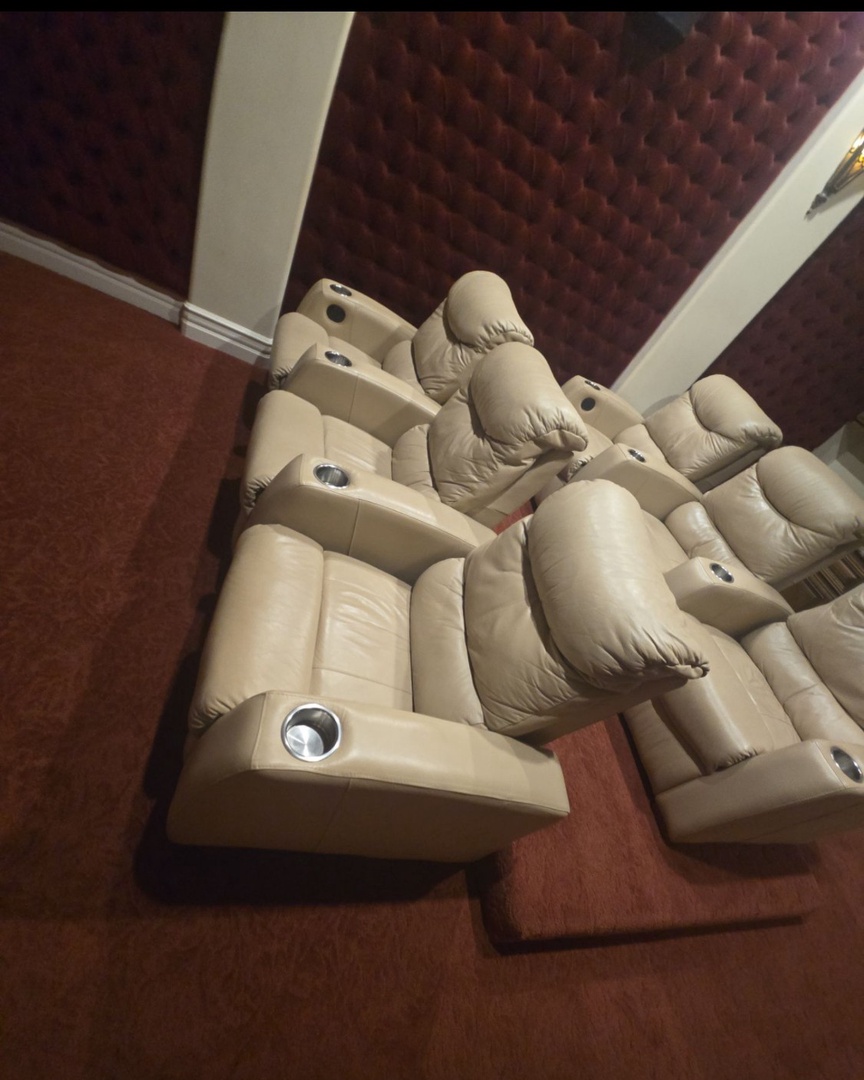 Settle into plush reclining seats with built-in cup holders—your private screening room awaits for cozy movie nights and entertainment with family or friends.
