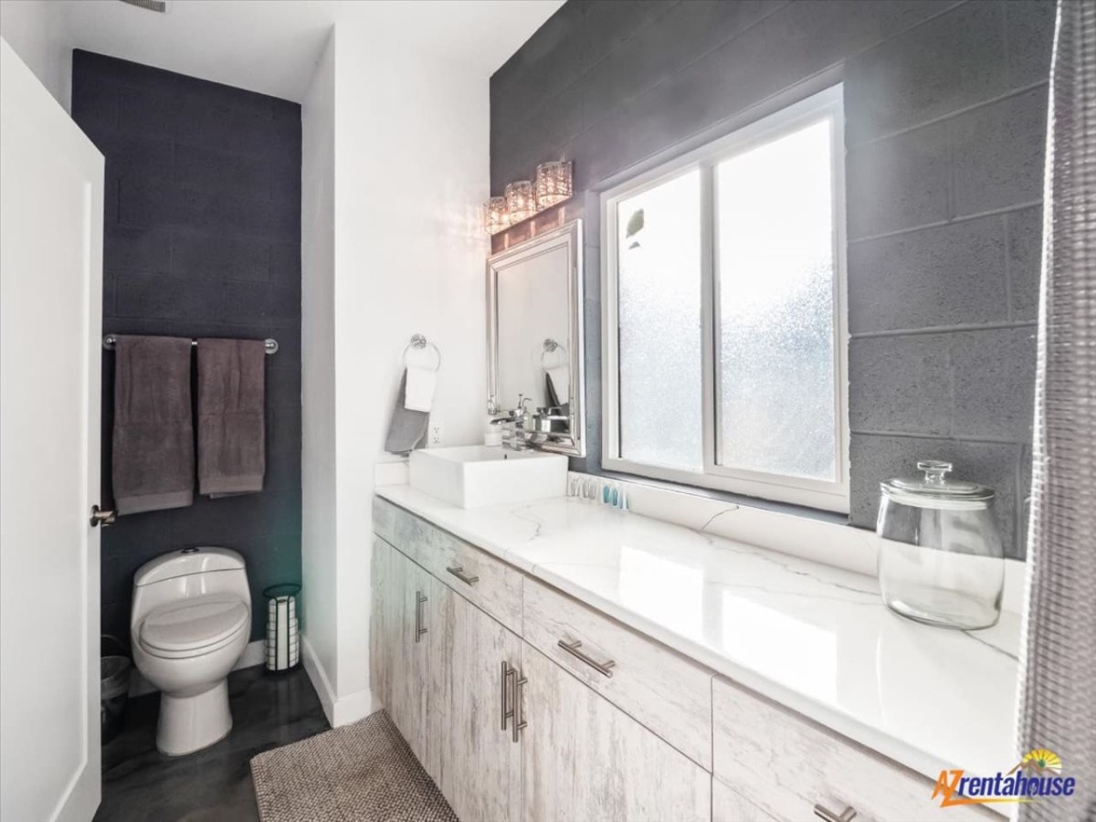 Step into your modern bathroom retreat with sleek gray tiles and bright natural light.