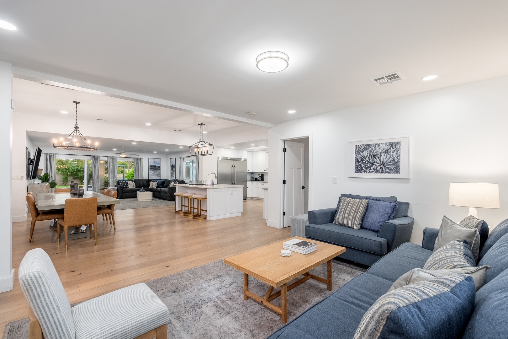 Settle into your spacious open-concept retreat where living, dining, and kitchen flow together seamlessly. Warm wood floors and calming blues invite you to relax and feel right at home.