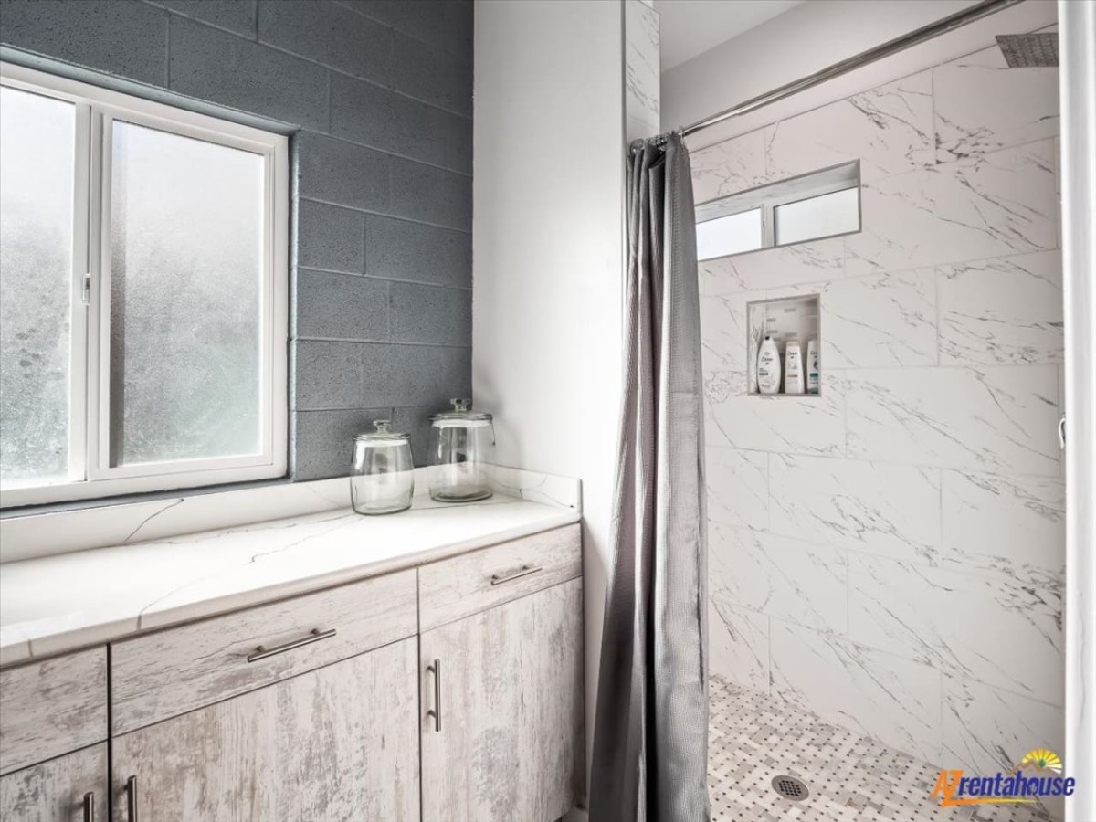 Refresh in your spa-like bathroom with marble-inspired shower, built-in niche for toiletries, and sleek vanity storage.