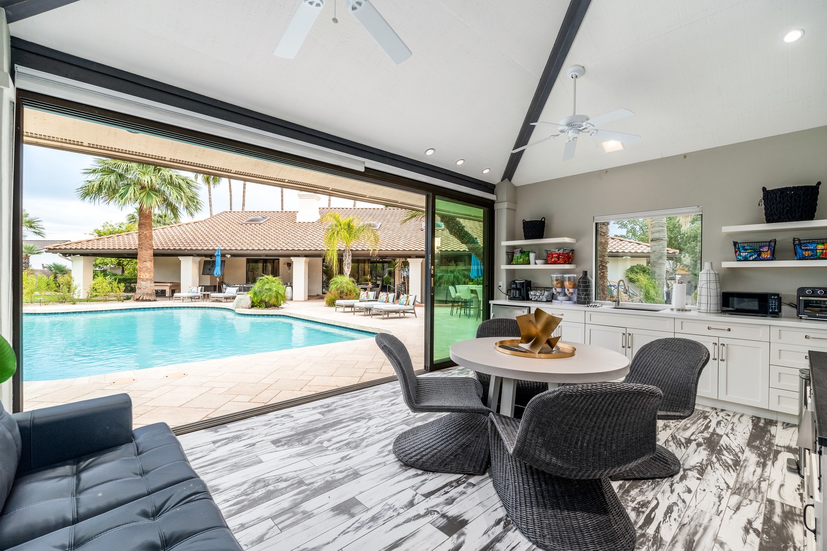 Step into your open-air retreat where indoor comfort meets poolside paradise. Sip morning coffee at your breakfast nook while soaking in stunning pool and garden views through expansive glass doors.