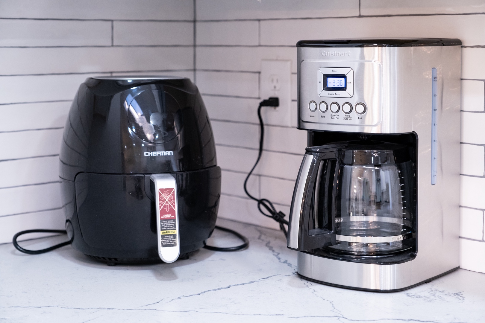 Modern kitchen appliances, including an air fryer and programmable coffee maker, make meal prep easy and convenient during your stay.
