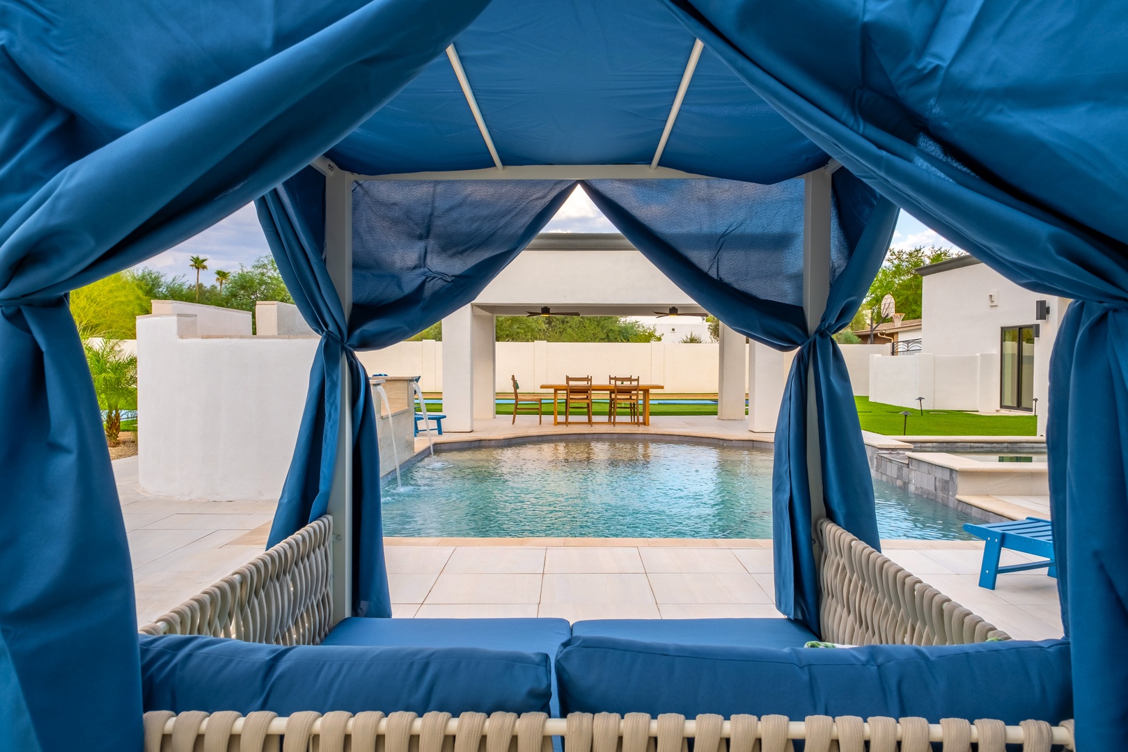 Lounge in your private poolside cabana, where the water shimmers and the lush yard beckons for lazy afternoons under Arizona sun.