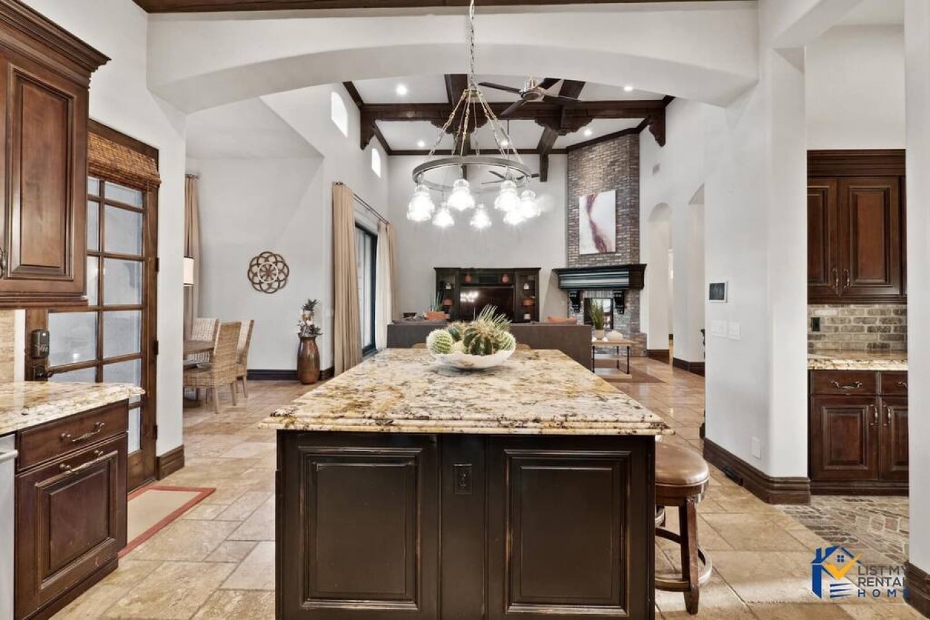 Your gourmet kitchen invites culinary adventures with granite counters, custom cabinetry, and elegant beamed ceilings creating the perfect cooking sanctuary.