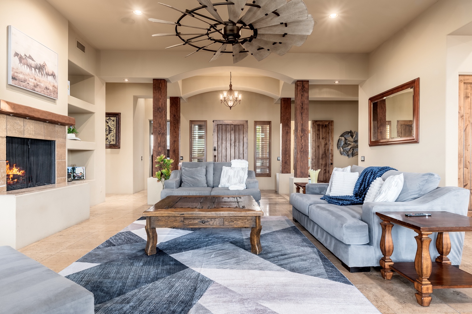 Unwind in this spacious living room where rustic charm meets modern comfort. Relax by the crackling fireplace, sink into plush sofas, and enjoy the soaring ceilings and warm wood accents that make this your perfect home away from home.