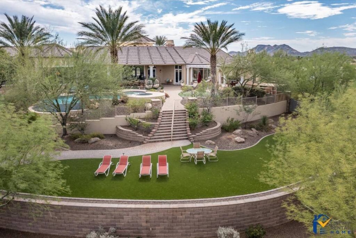 Stunning desert estate surrounded by native Sonoran landscape with mountain views, featuring private pool, spa, and manicured lawn for outdoor relaxation.