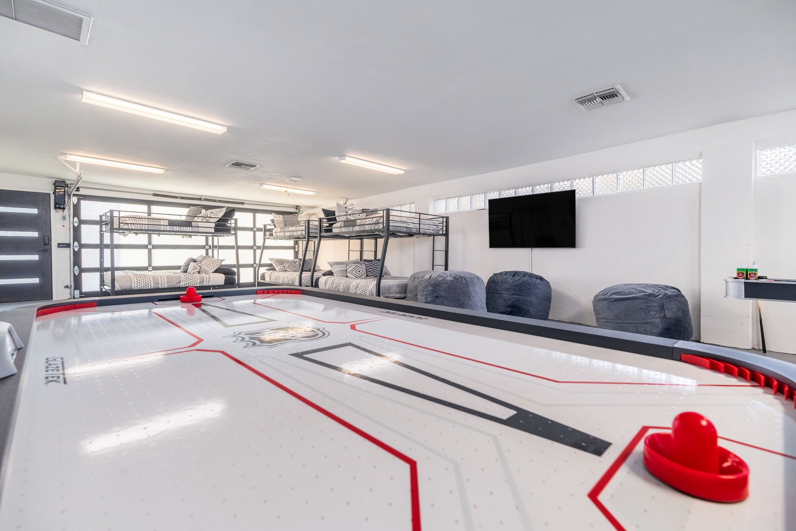 Challenge your group to friendly air hockey matches in this bright game room, featuring bunk beds for the kids and cozy bean bags for spectators.
