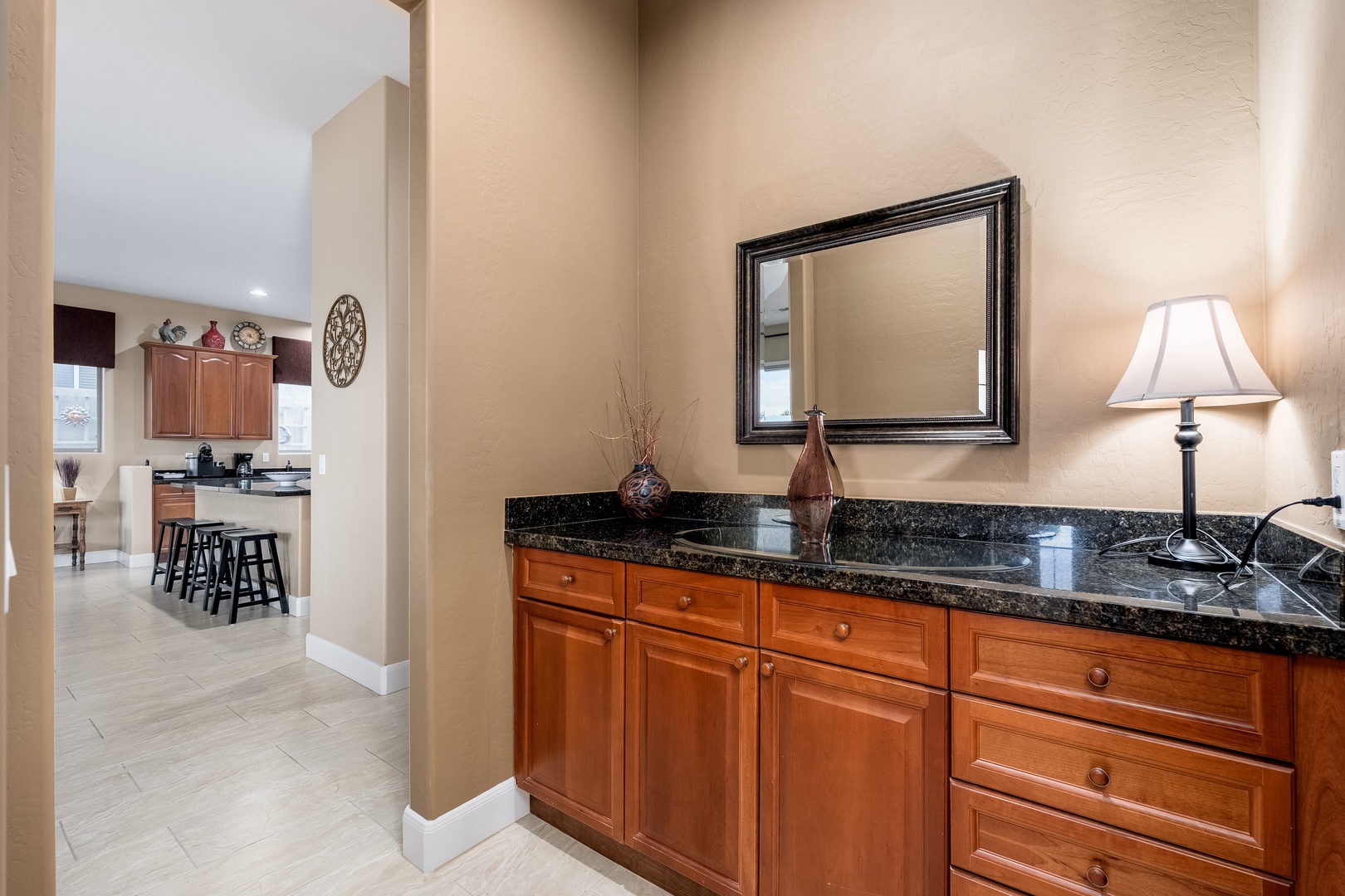 An elegant granite vanity with custom cabinetry offers your personal retreat, while warm lighting and thoughtful décor create a spa-like atmosphere where you can unwind.