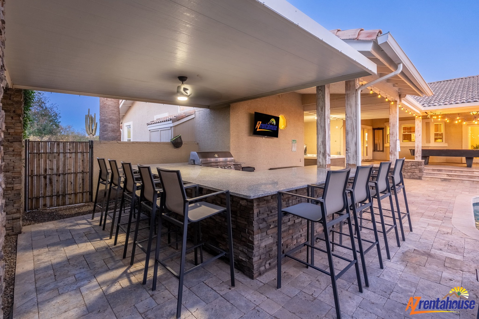 Gather around the outdoor bar and enjoy Arizona evenings with built-in grilling and TV entertainment under covered comfort.