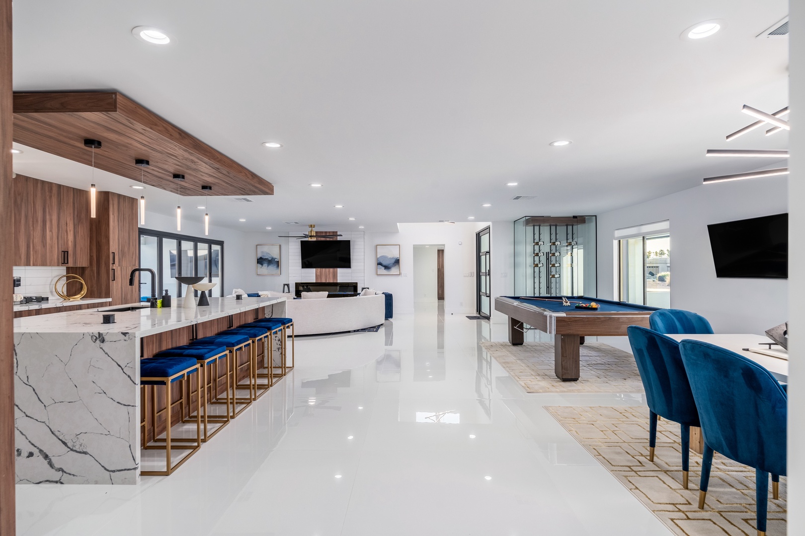 Step into your open-concept space where sleek marble counters, luxe velvet seating, and a billiard table invite you to relax and entertain in style.