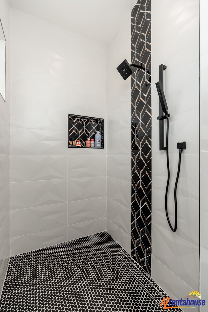 Step into your sleek shower featuring elegant geometric tile accents and modern fixtures for refreshing daily rituals.