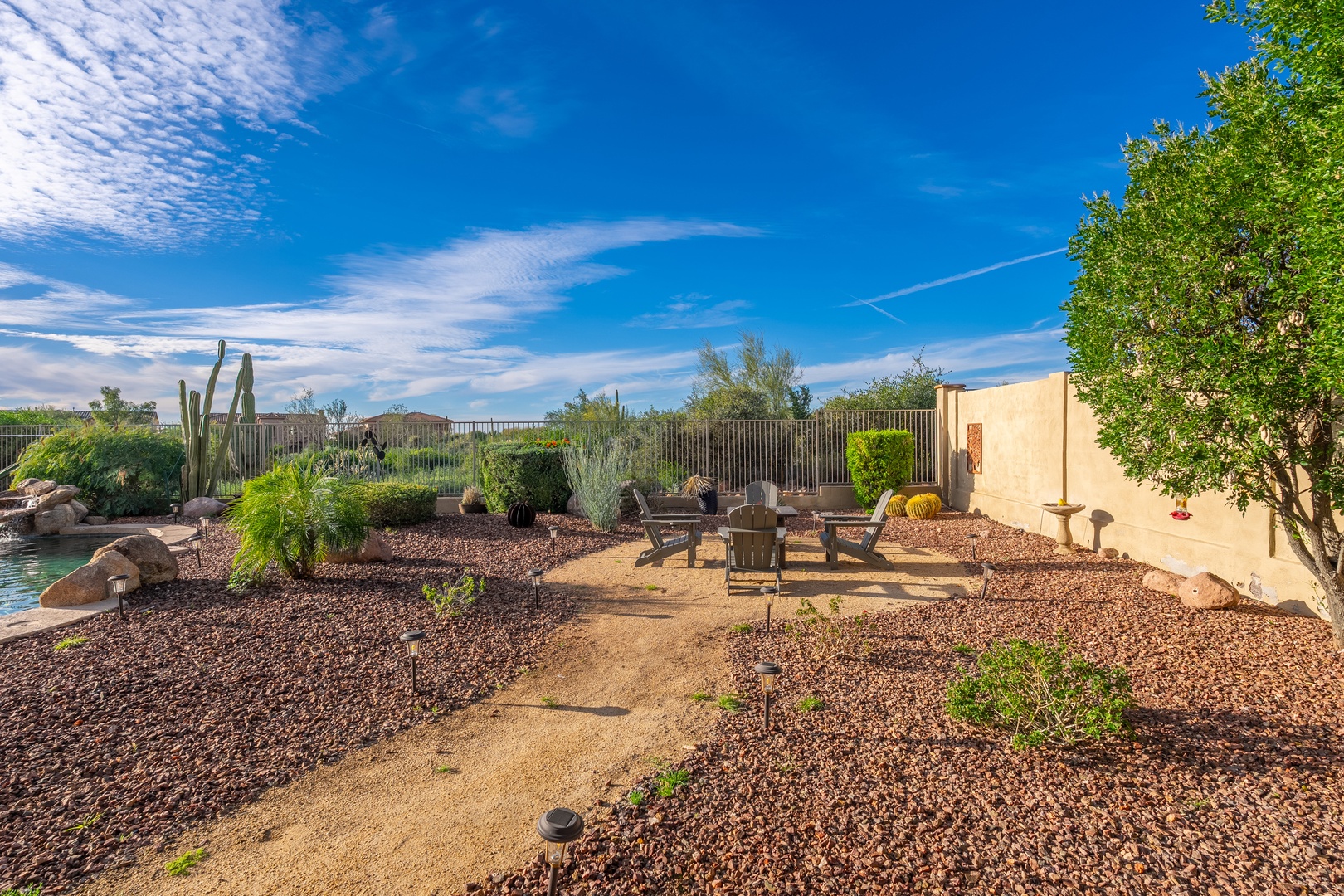 An expansive desert garden with native cacti and desert landscaping, offering a peaceful outdoor space for relaxation beneath beautiful Arizona skies.