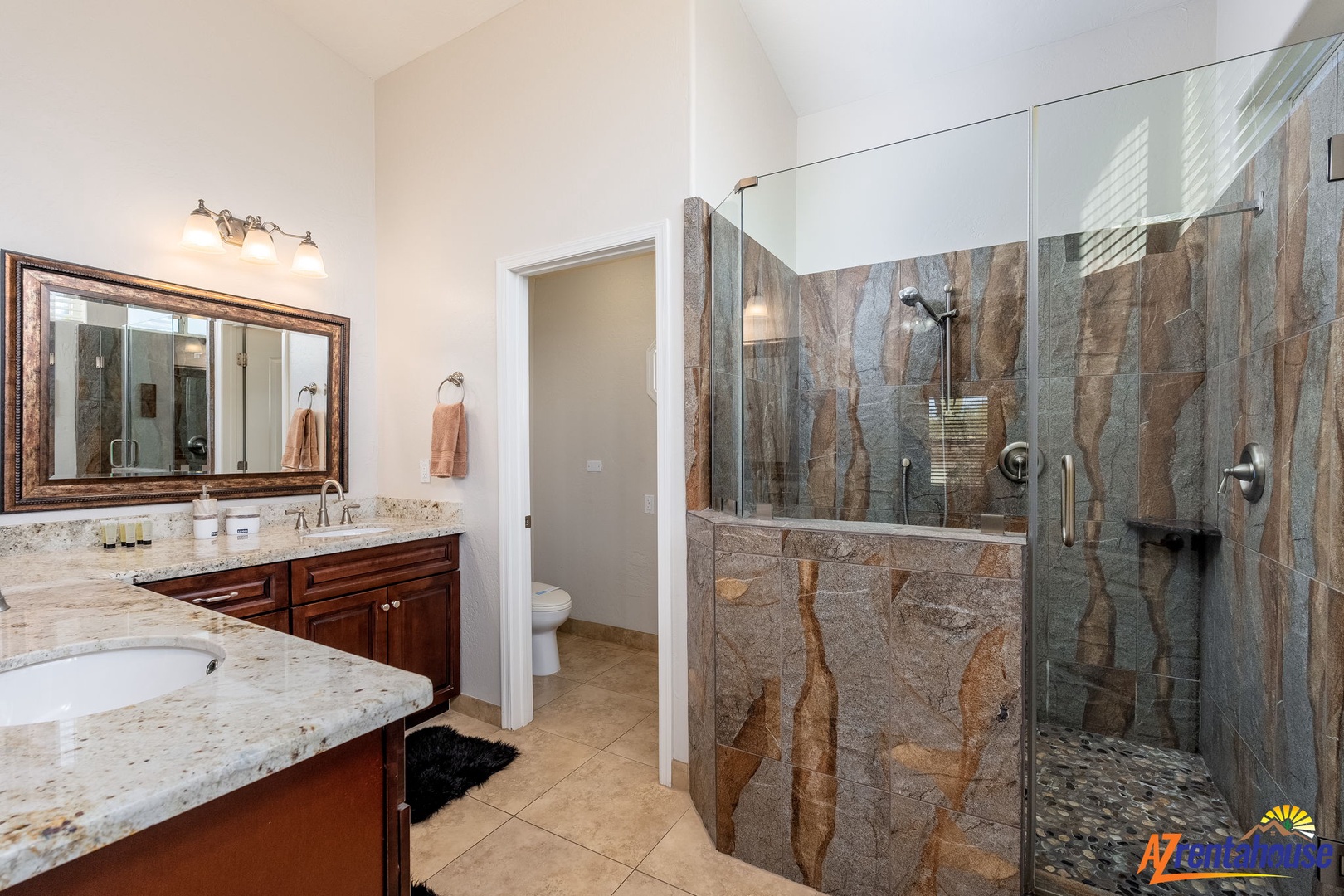 Unwind in your private spa-like retreat featuring granite counters, dual vanities, and a stunning walk-in shower with designer tiling that blends natural stone elegance with modern comfort.