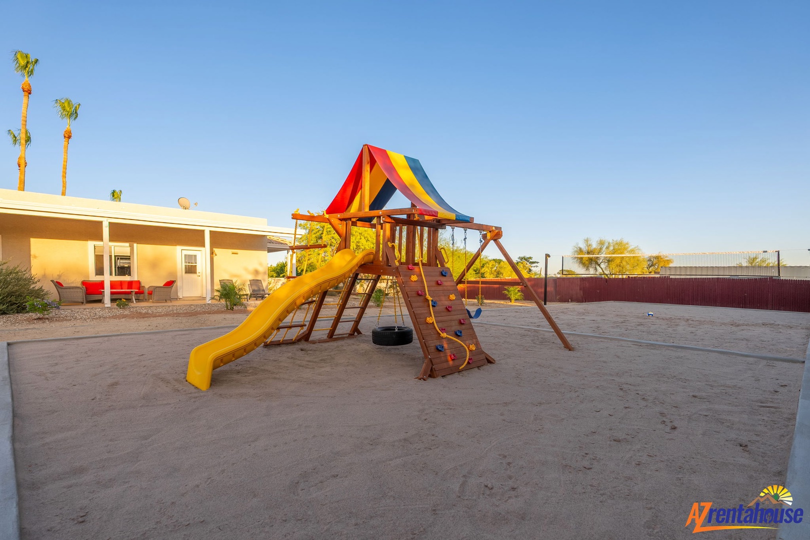 This spacious desert playground features a vibrant playset with slides, swings, and a climbing area where your little ones can play under sunny Arizona skies—perfect for family fun.