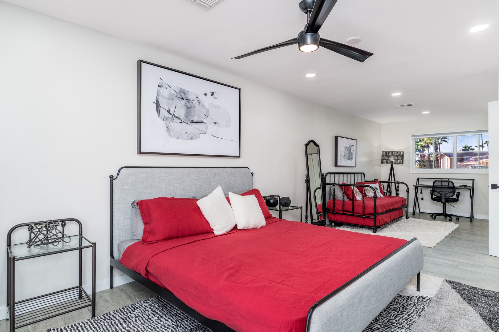 Slip into crisp white linens and enjoy a restful night in this bright bedroom with modern décor, plus workspace and extra sleeping options for your group.
