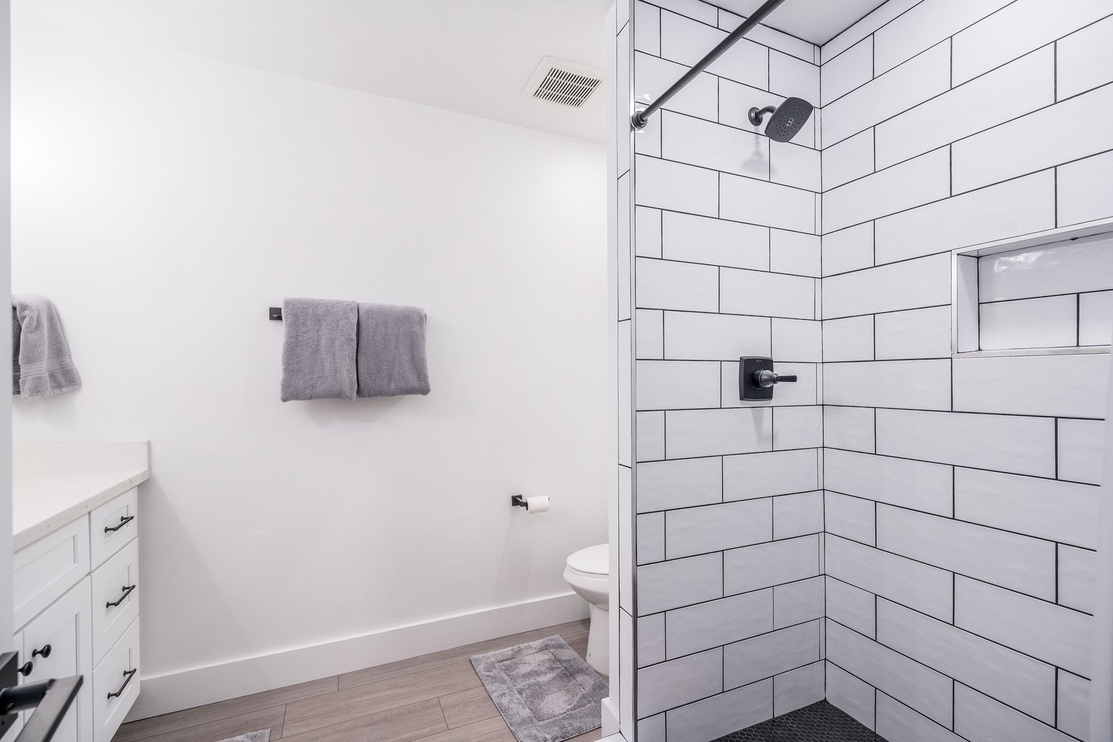 Step into your pristine bathroom with modern subway tile shower, fresh towels waiting, and clean lines throughout—perfect for refreshing after a day of adventure.