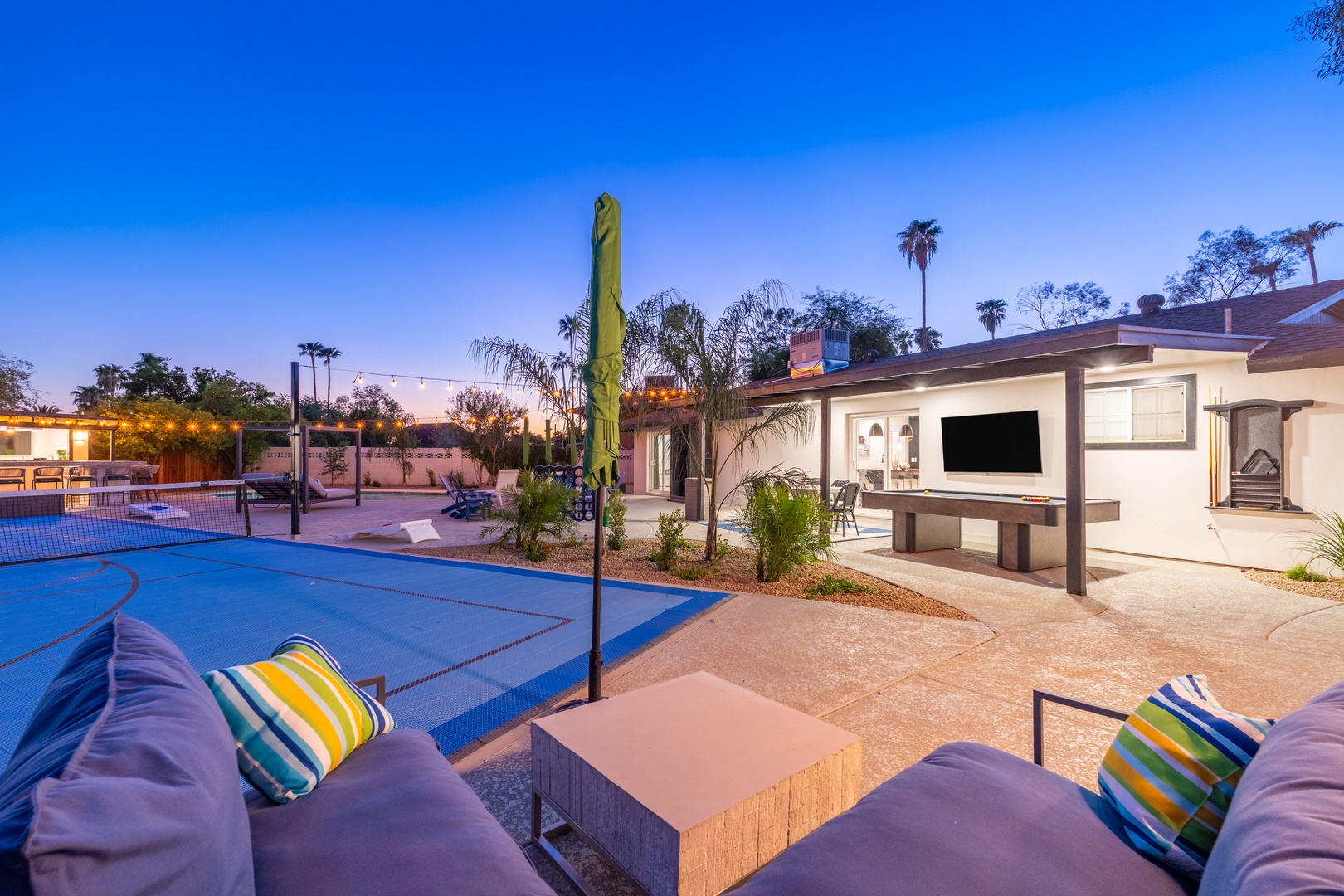 Catch the evening glow from your private outdoor haven—where sports, lounging, and entertainment come together under desert skies and string lights.