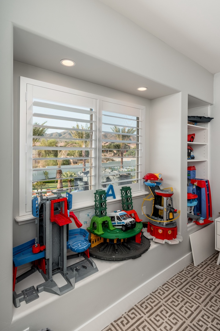 A bright play alcove where your little ones can let their imaginations soar, with built-in storage for easy tidying and a cheerful window overlooking the neighborhood.