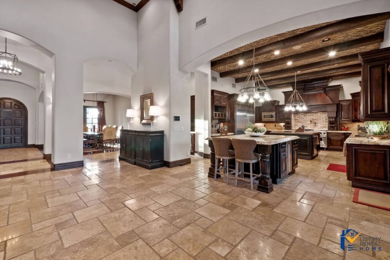 Soak in the grandeur of exposed wooden beams and elegant stone floors as you gather around the spacious kitchen island for memorable meals.