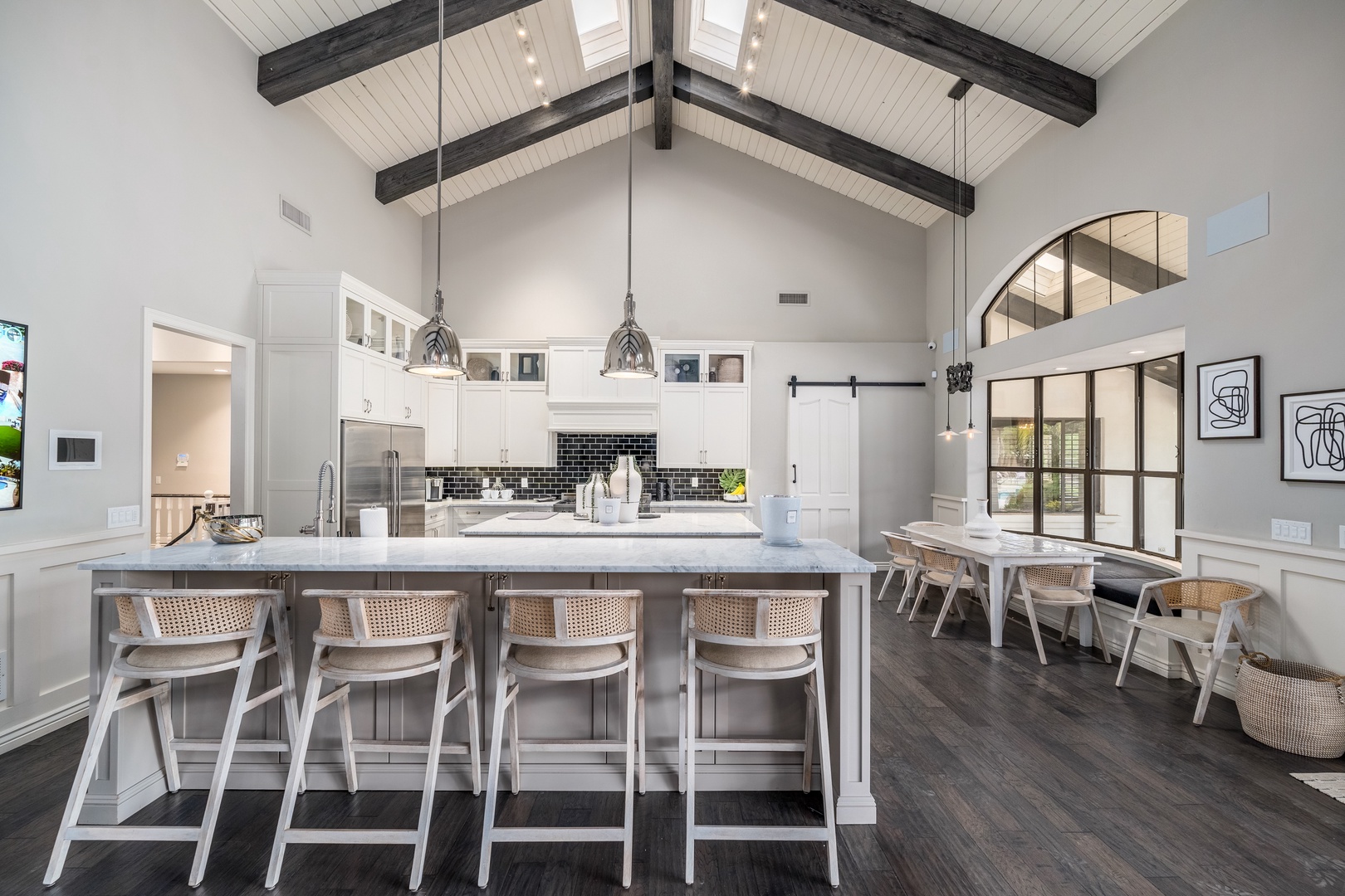 Gather around this stunning kitchen island with vaulted ceilings and marble countertops. The open layout flows into your dining space, perfect for memorable meals together.