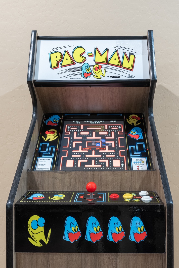 A classic Pac-Man arcade game is ready for your next gaming session, complete with original graphics and joystick controls.