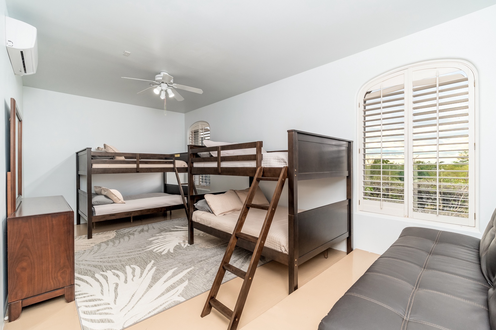 Gather everyone in this bright bunk room, where you'll find cozy beds for restful nights, a ceiling fan for comfort, and natural light inviting peaceful mornings.