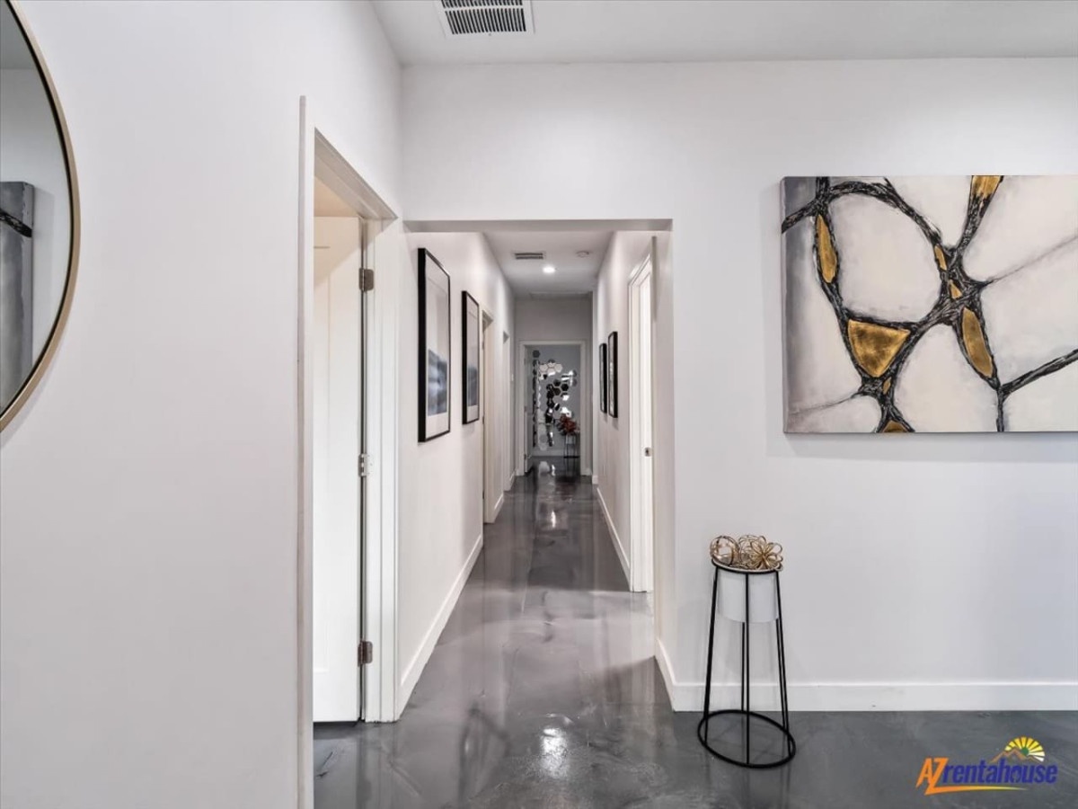 You'll love moving through this sleek hallway with polished concrete floors and contemporary artwork that sets a sophisticated tone for your stay.