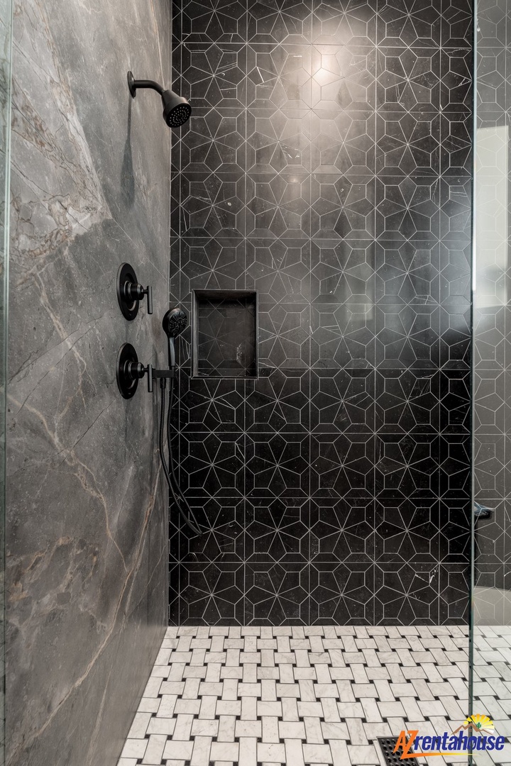 Step into your luxurious walk-in shower featuring stunning geometric tile work and premium fixtures for the ultimate spa-like experience.