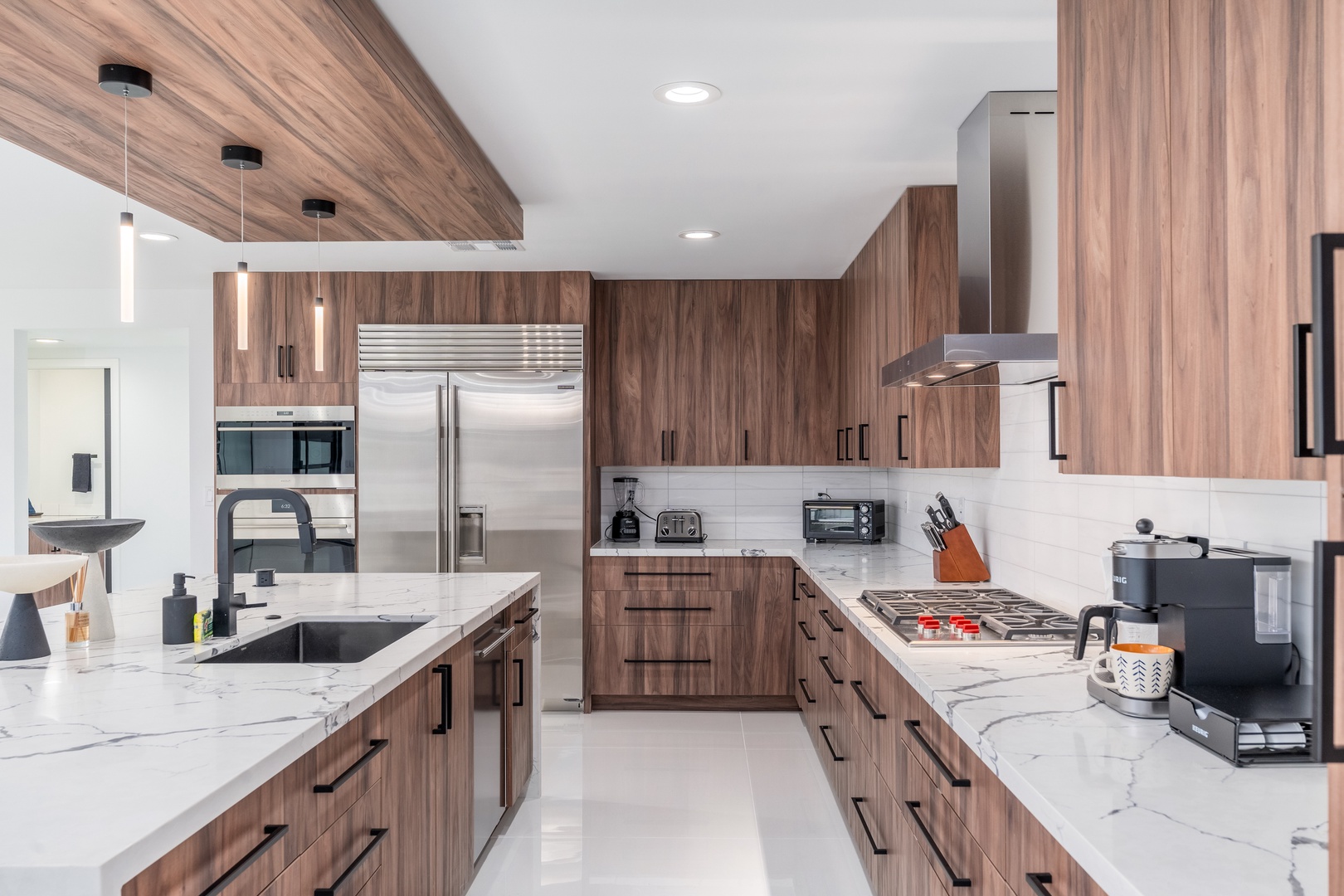 Your dream vacation kitchen awaits—sleek walnut cabinetry meets gleaming marble countertops in this chef-ready space. Cook, gather, and create memories with high-end appliances and ample prep space designed for your comfort.