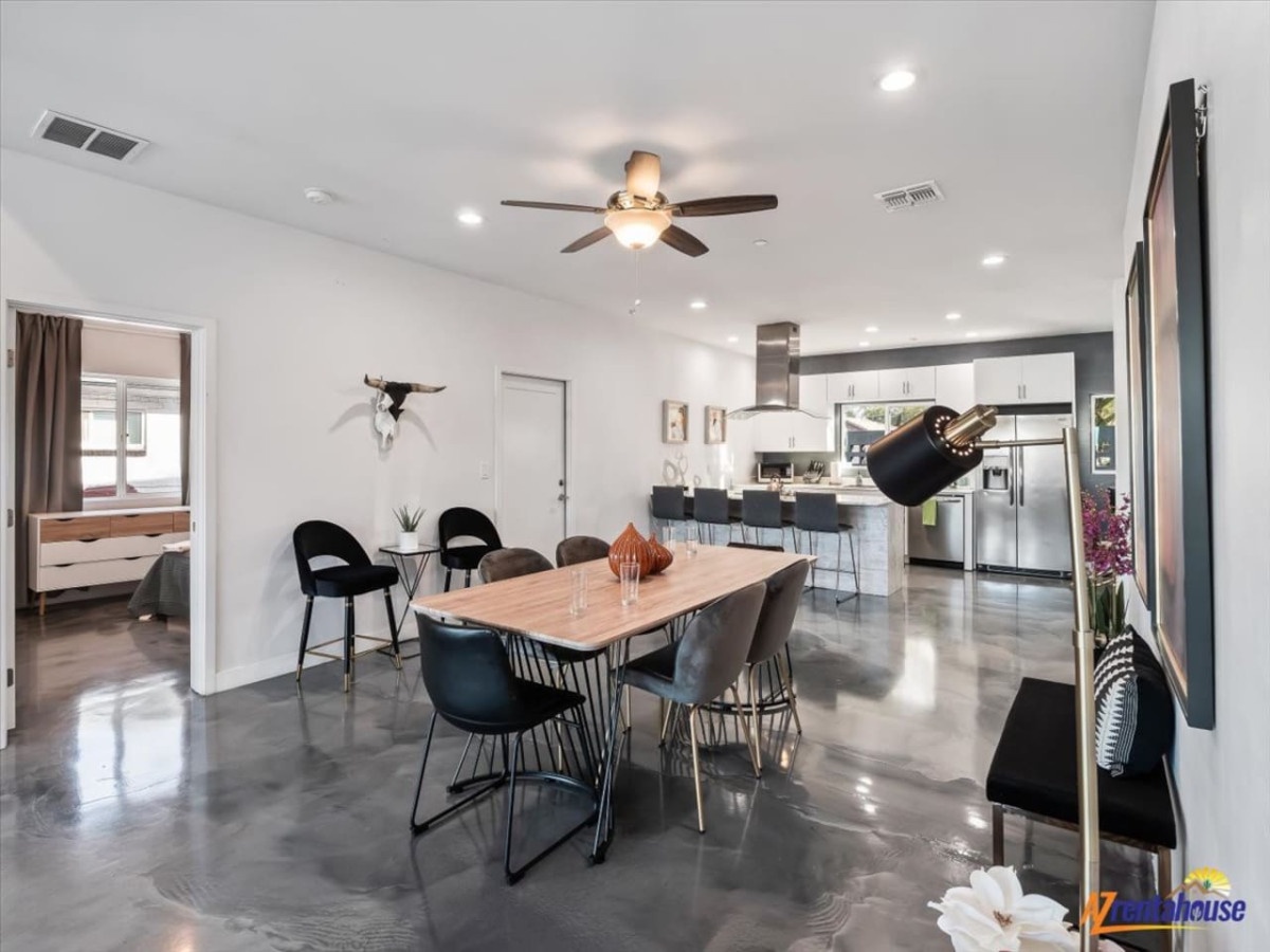 Step into your sleek open-concept living space where modern design meets comfort. Gather around the stylish dining table while meals cook in your fully equipped kitchen.
