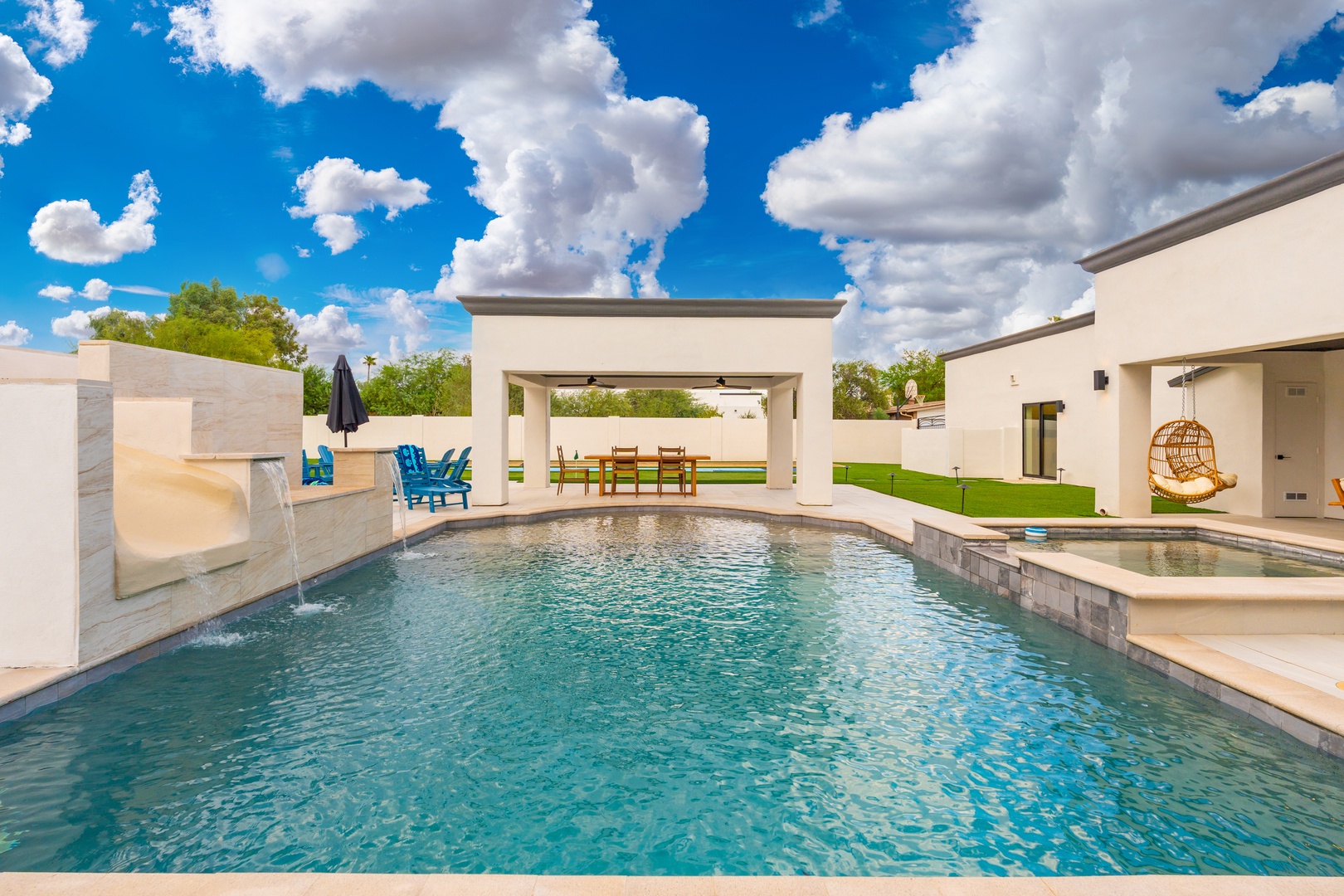 Your private oasis awaits with crystal-clear water, a waterslide, covered dining, and Arizona's endless blue sky overhead—perfect for relaxation and fun.