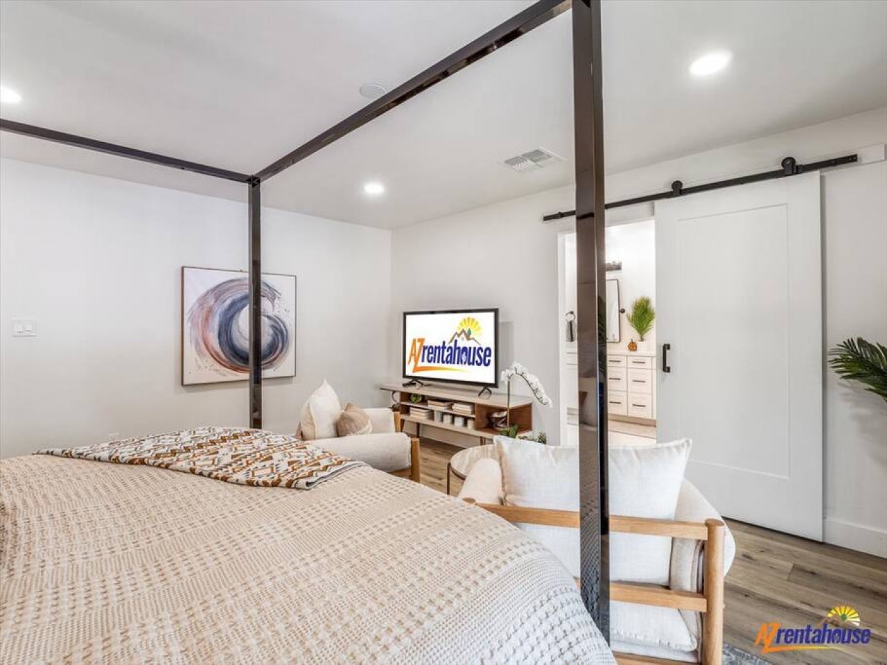 Unwind in your stylish canopy bed with crisp linens, while enjoying entertainment on the mounted TV in this bright, contemporary retreat.