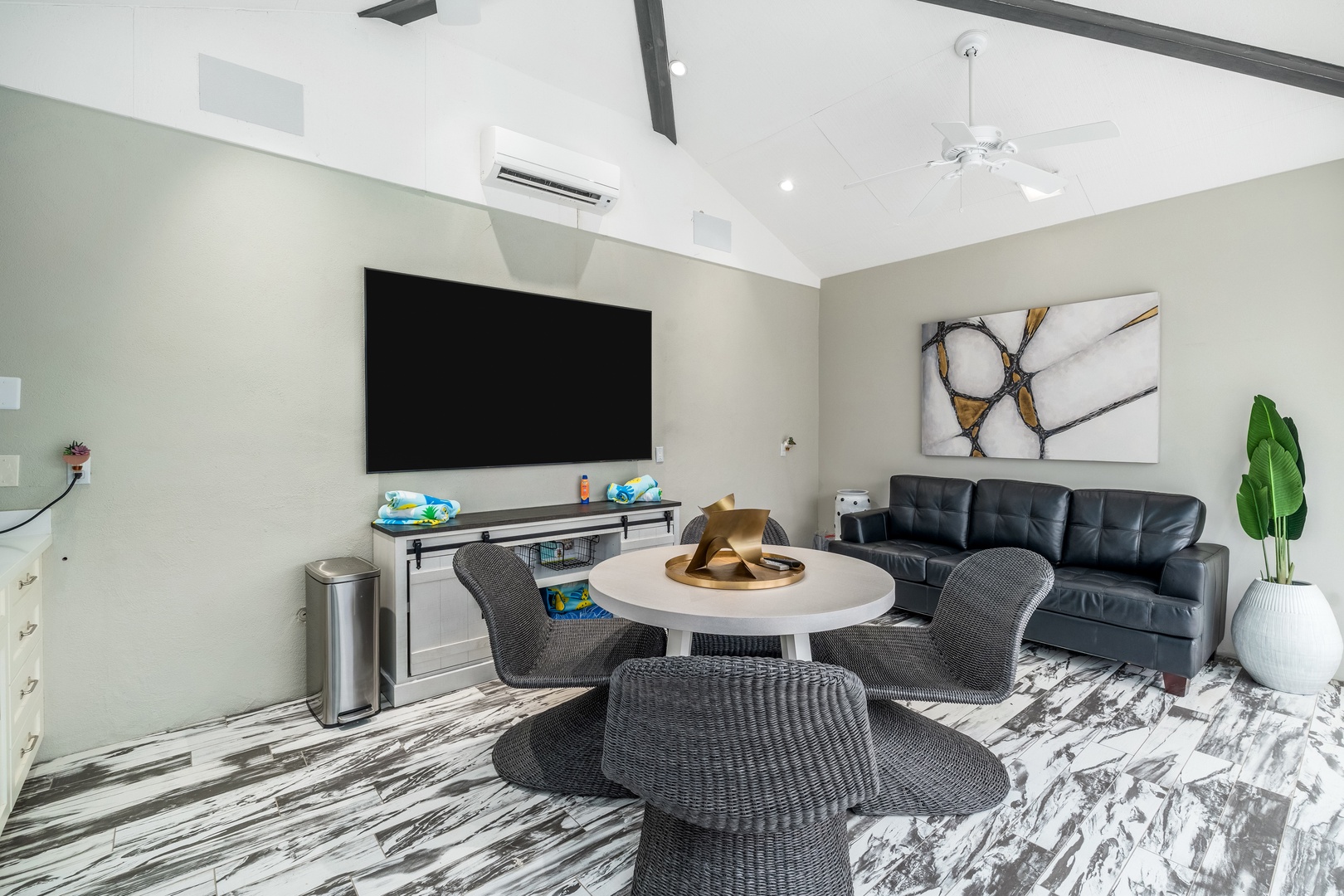 Your modern living space features vaulted ceilings with exposed beams, a large entertainment area, and stylish seating for relaxing evenings. Enjoy cool comfort with air conditioning and thoughtful touches throughout.