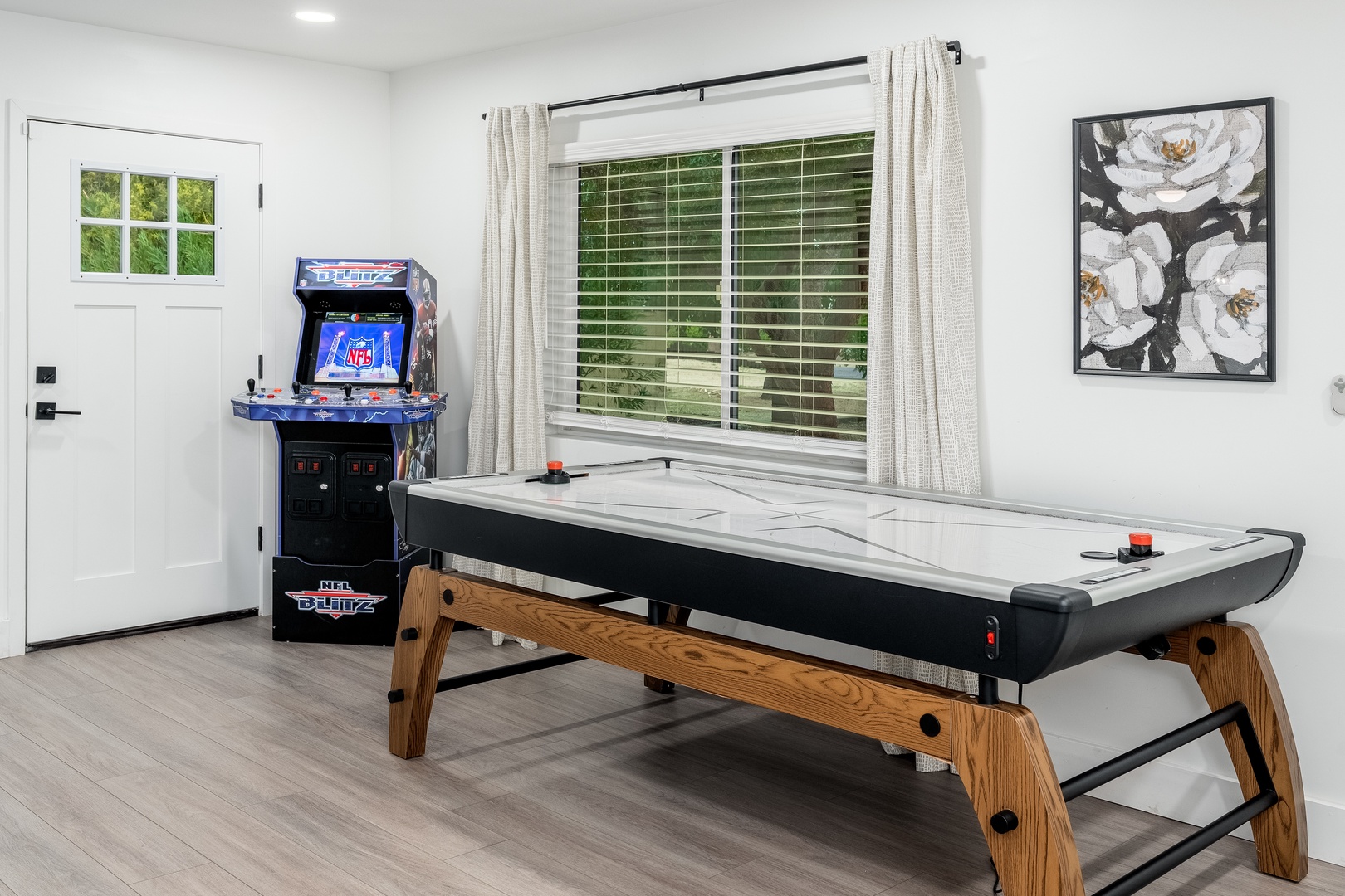 Your private game room awaits, complete with air hockey and a classic arcade machine for friendly competition and endless entertainment during your stay.