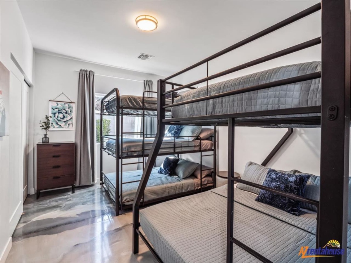 Your group will love this spacious bunk room with comfortable beds, stylish decor, and plenty of storage for everyone's belongings.