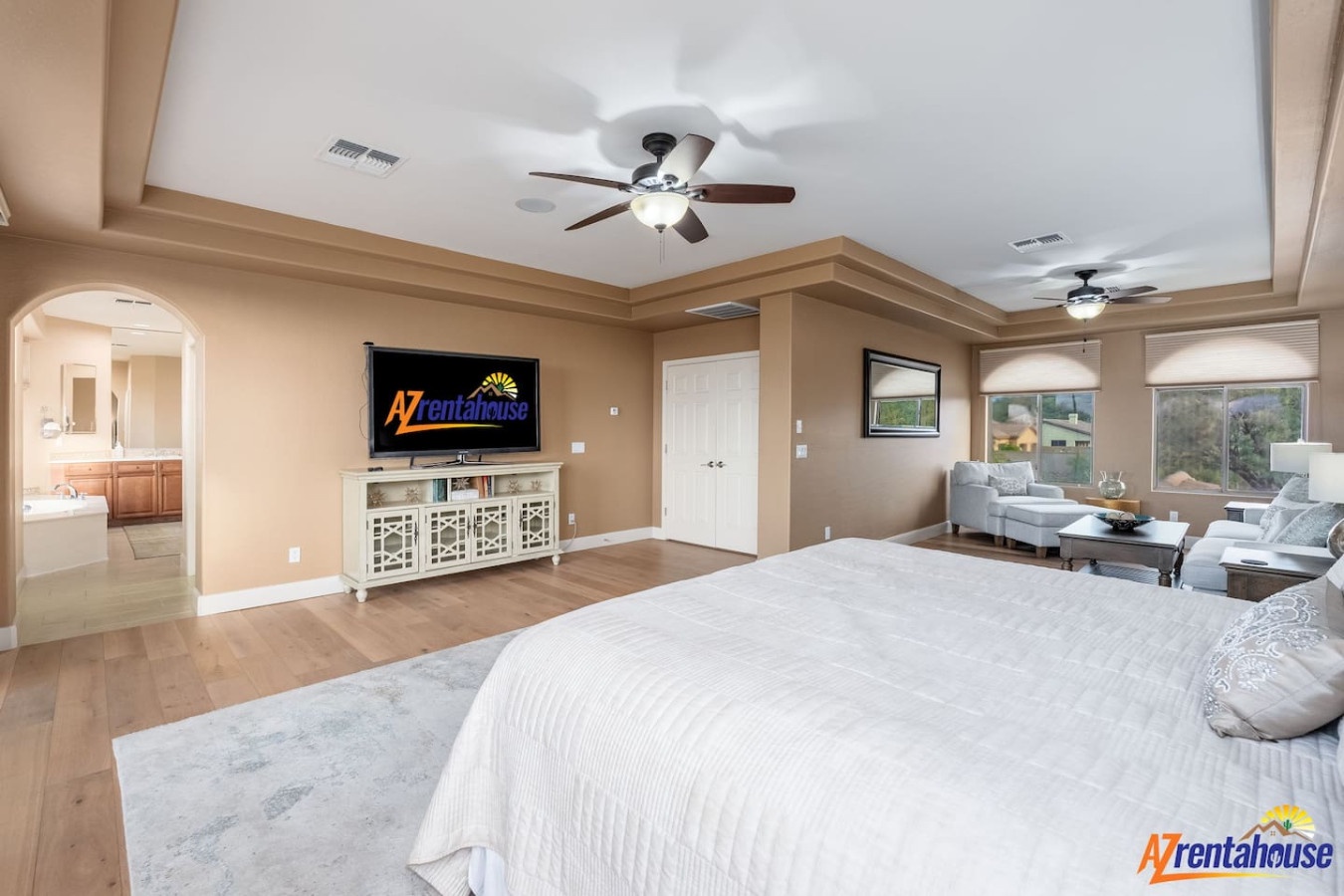 Your spacious master bedroom offers elegant comfort with a cozy sitting area and entertainment center for ultimate relaxation.