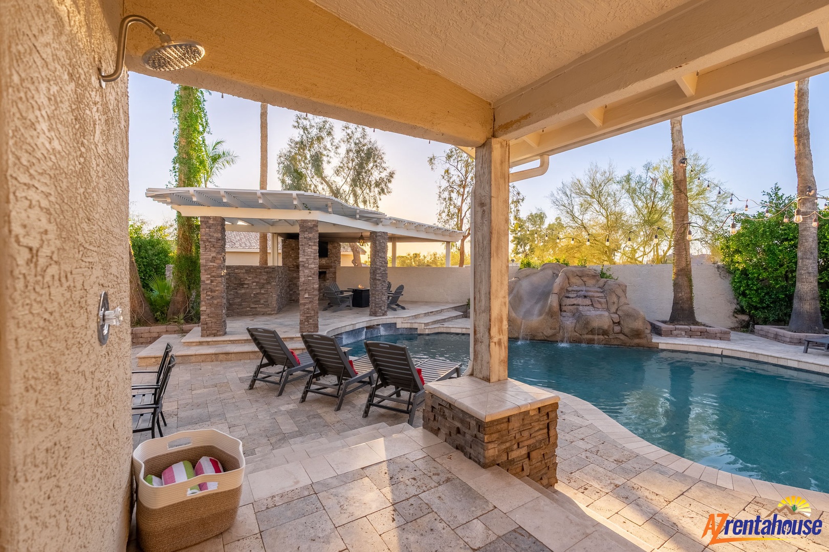 Covered patio with loungers, pool access, and an outdoor shower to rinse off after a refreshing swim.