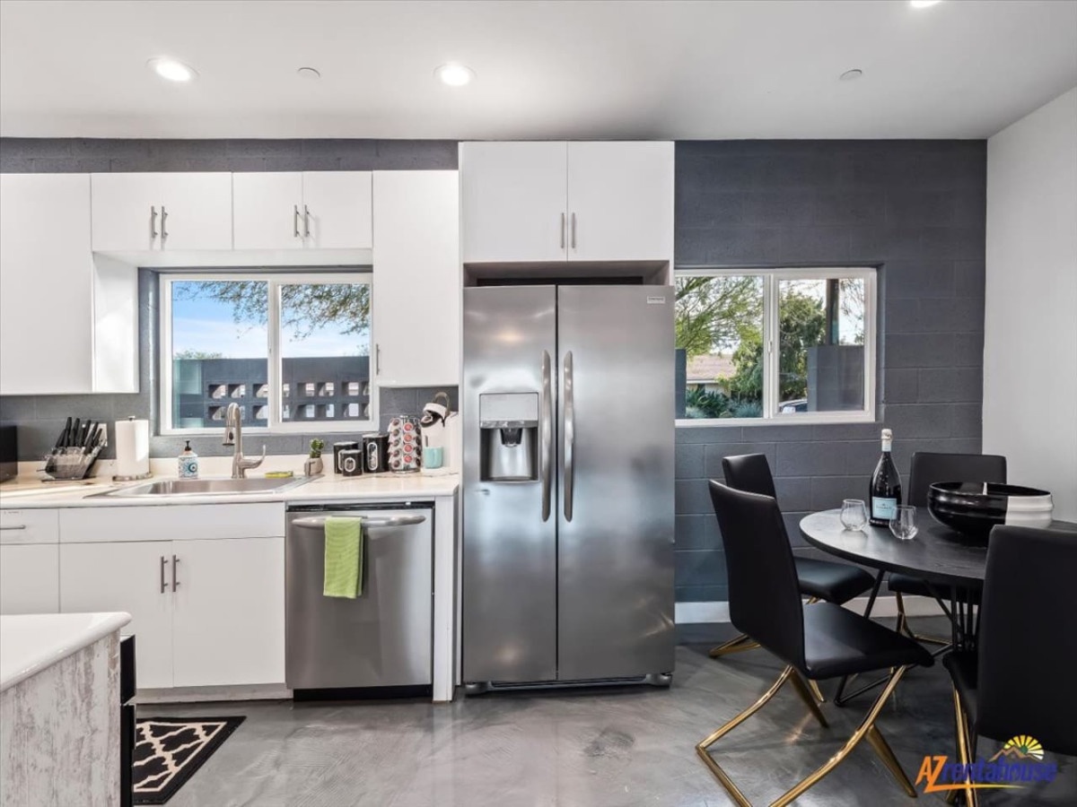 Cook together in your modern kitchen featuring stainless steel appliances and elegant dining space for memorable meals.