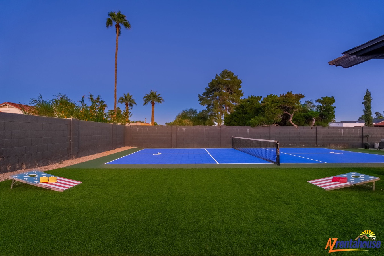 Your private tennis court awaits with premium artificial turf and cornhole games for endless entertainment under desert palms.