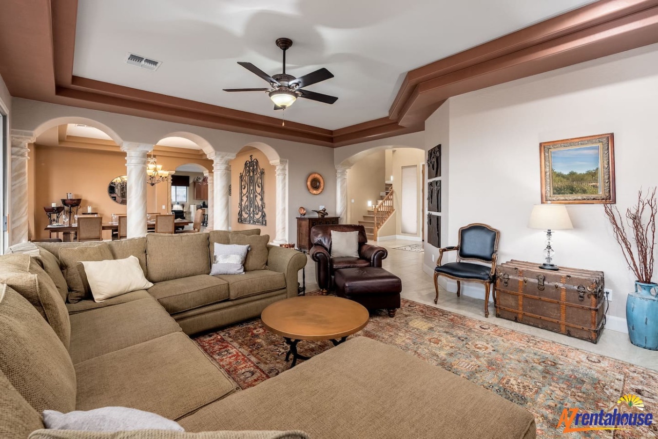 Relax in this elegant living room with plush sectional seating, rich wood details, and soaring ceilings for your perfect retreat.