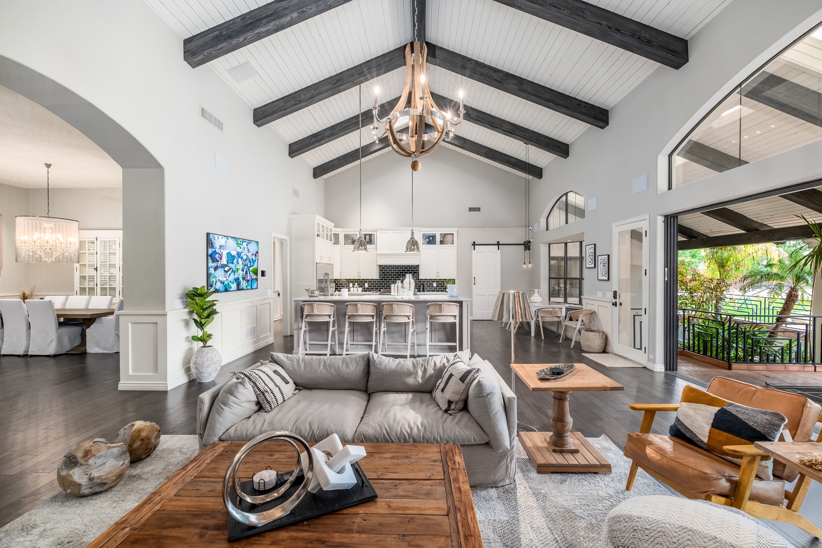 You'll love the soaring beamed ceilings and open-concept design that flows from your living space through the chef's kitchen to the sunny outdoor patio. Perfect for gathering, relaxing, and making memories in style.