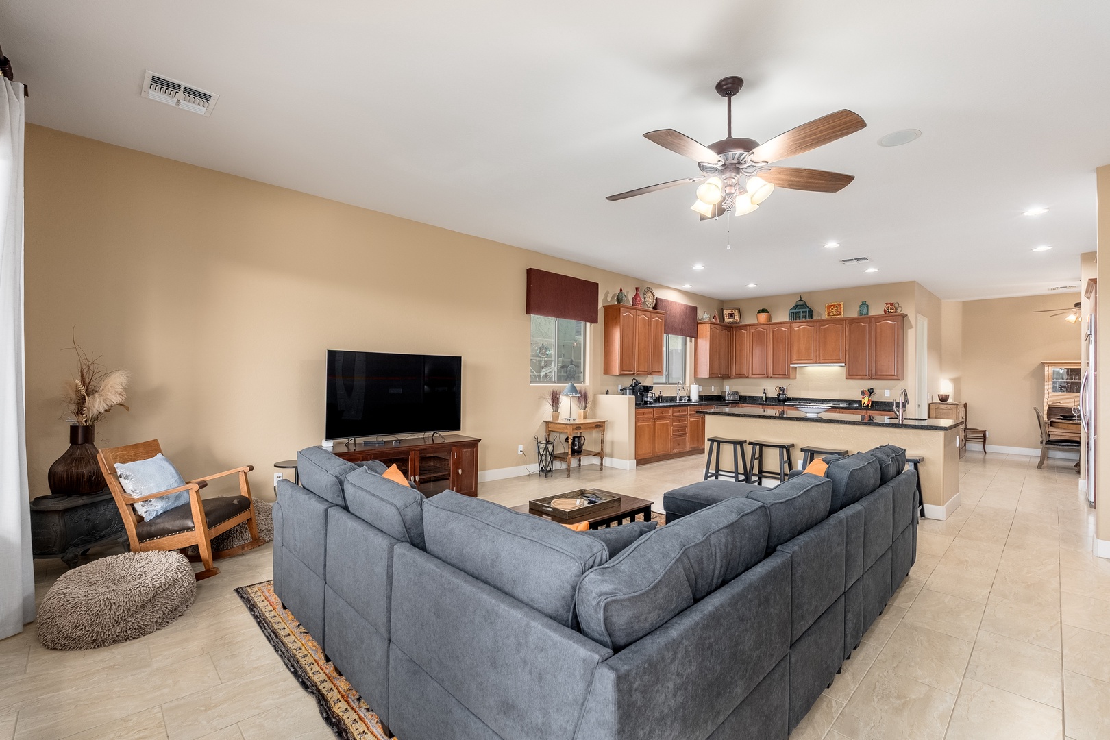 Settle into the spacious open-plan living area where plush seating, a fully equipped kitchen, and warm lighting create your perfect home base for unforgettable desert escapes.