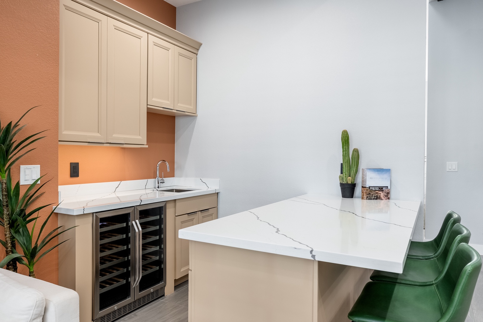 Your stylish kitchenette features sleek marble countertops, modern cabinetry, and a wine cooler—perfect for preparing light meals or enjoying refreshments in comfort.
