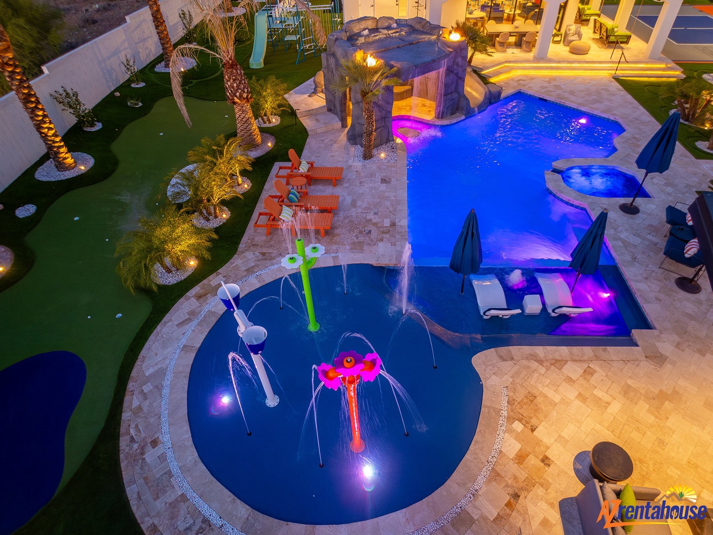 Spectacular resort-style backyard oasis features illuminated pools, hot tub, and mini-golf for your perfect desert retreat.
