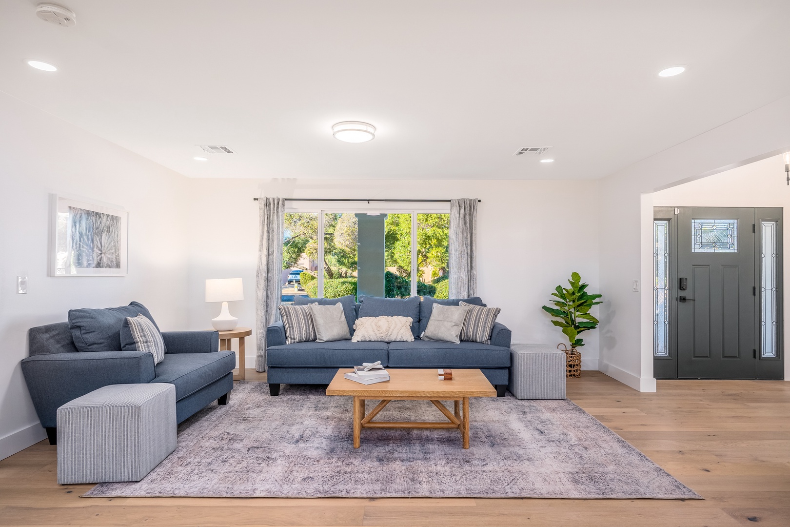 Picture yourself unwinding on plush sofas bathed in natural light, with lush garden views through expansive windows creating your perfect retreat for relaxation and connection.