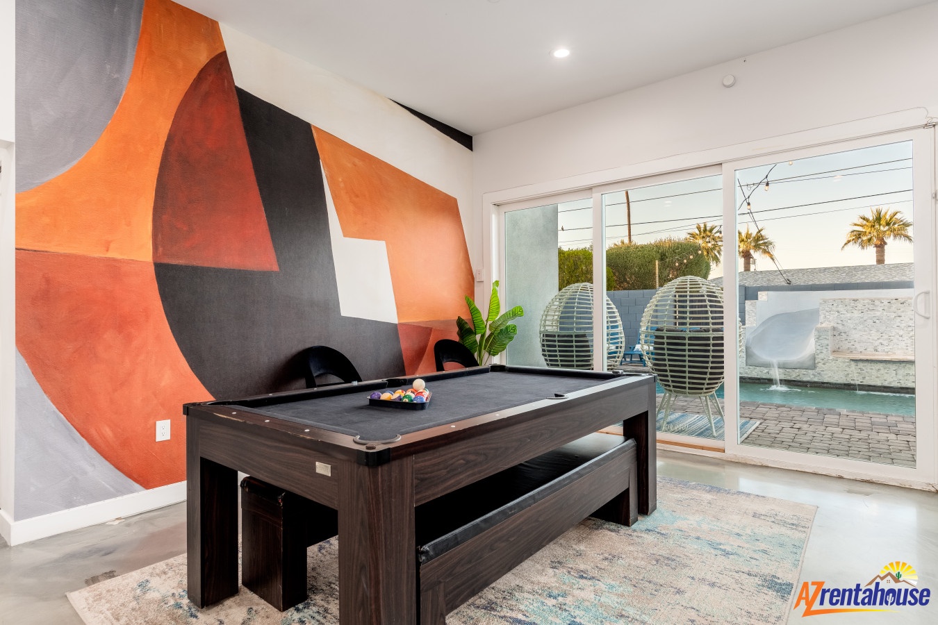Challenge friends to pool games in your stylish game room with vibrant art and pool views.